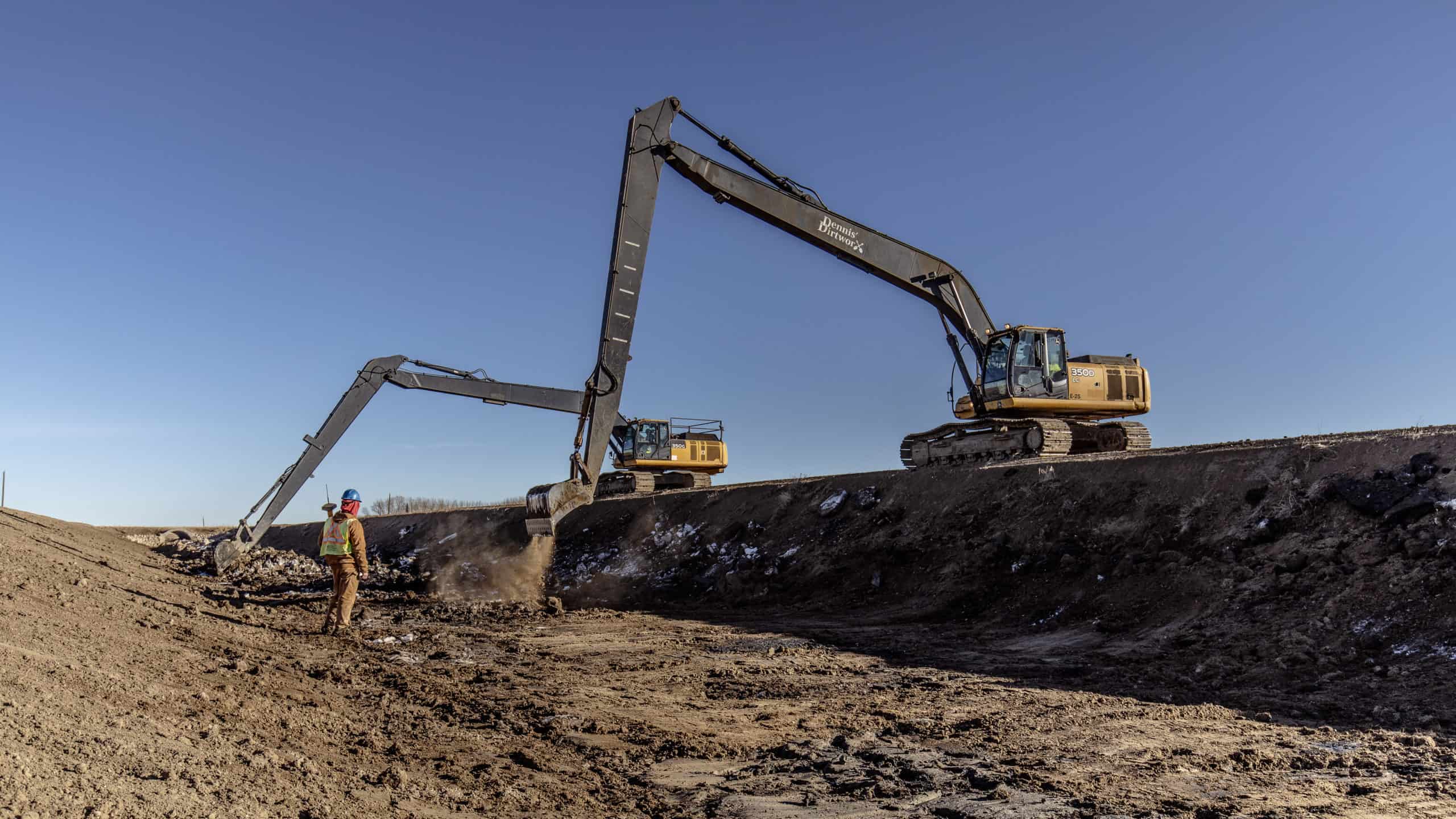 Dennis DirtWorx crew member working with long-reach excavators